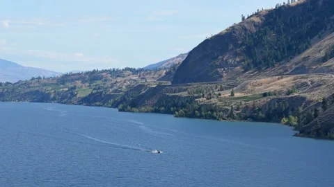 Drone view of a speed boat moving at high speed in Okanagan Lake Stock Footage 247943811