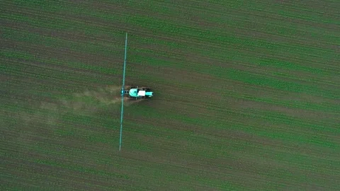 Drone view of a sprinkler tractor processes a soybean field with chemicals. Top 스톡 동영상 248050744