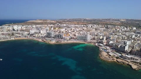 Drone view of St Paul's Bay and Bugibba waterfront on sunny day in Malta Stock Footage 339327160