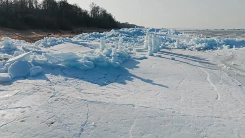 Drone view of stacked ice towers creating striking symbols across frozen coast Stock Footage 341845842