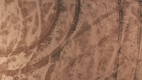 Drone view straight down moving up and revealing the circles in the sand Stock-Footage 164798929