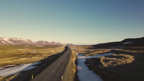 Drone View of Straight Road in the Middle of Green Fields With Bright Sky Stock-Footage 156497499