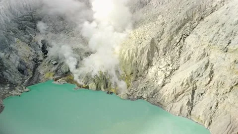 Drone View of Sulfur Miners Working Amid Fumes at Kawah Ijen Stock Footage 315224409