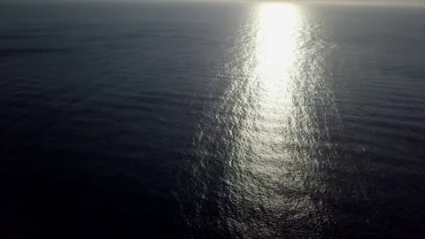 Drone view of the sunlight reflection on the sea in a clear evening. Video stock 221738961