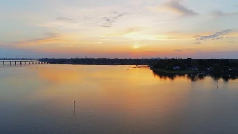 Drone view of a sunrise shot over Portsmouth Virginia from over the water Stock Footage 106961108