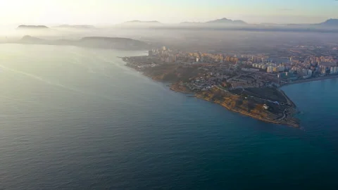 Drone view of sunset behind lighthouse of Cape Huertas, Spain. Stock Footage 325829640