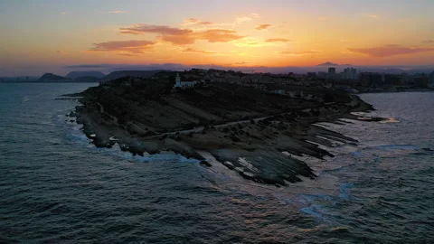 Drone view of sunset behind lighthouse of Cape Huertas, Spain. Stock Footage 325835250