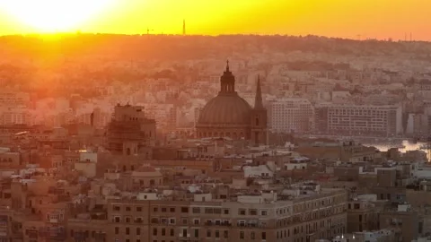 Drone view of sunset over main cathedral in Valletta city, Malta island Stock Footage 279385386