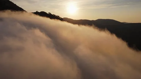 Drone view of sunset over misty Spanish mountain Видео 314605702