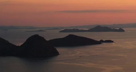 Drone view of sunset over ocean horizon and island silhouettes Stock Footage 333053353
