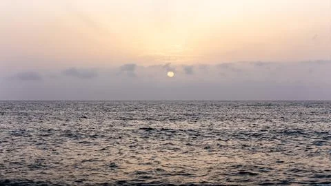 Drone view of sunset over the ocean waves at a quiet beach Stock Photos