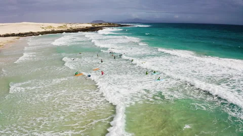 Drone view of of surfers in the beach. Stock Footage 291992047