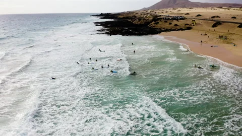 Drone view of of surfers in the beach. Stock Footage 291997770