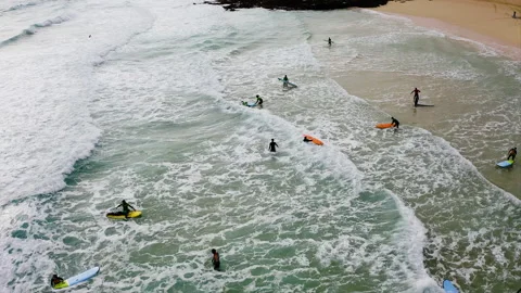 Drone view of of surfers in the beach. Stock Footage 291998130