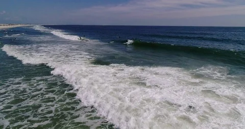 Drone view Surfers riding waves Long Island NY Stock Footage 116613354