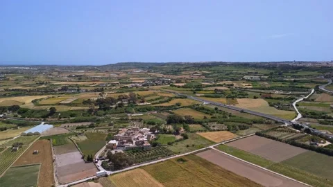 Drone view of Ta' Qali fields and farmhouses amid Mediterranean greenery Stock Footage 336469086