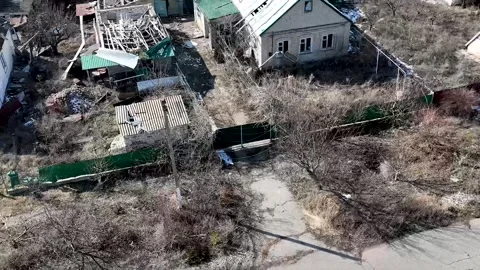 Drone View: Tactical Scouting of Destroyed Village and Rural Roads Stockbeeldmateriaal 332354785