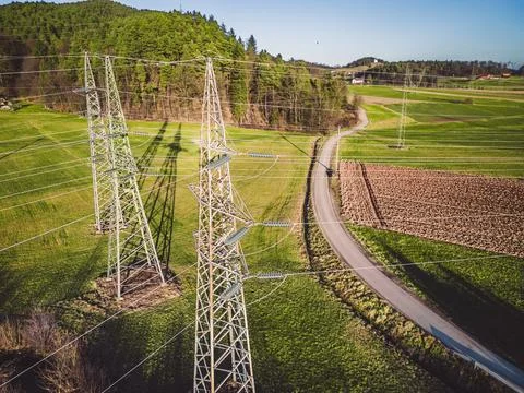 Drone view of three electrical power towers in the countryside Stock Photos