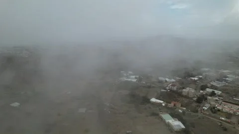 Drone view through the clouds at slow speed. flying over foggy Stock Footage 263277660