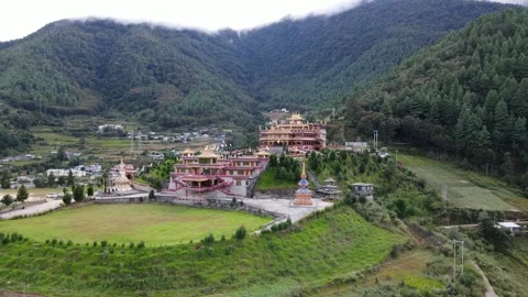 Drone view of Thupsung Dhargye Ling Monastery surrounded by green lush 動画素材 346250890