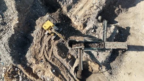 Drone view of a tire recycling facility with a large pile of old car tires Stock Footage 294722742