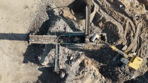 Drone view of a tire recycling facility with a large pile of old car tires Stock Footage 294722755