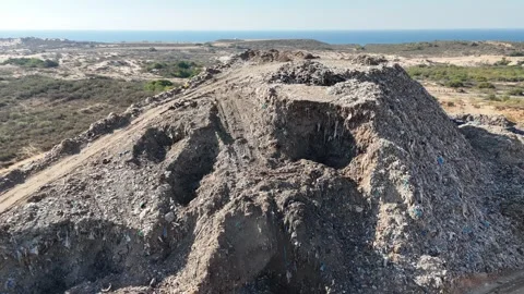 Drone view of a tire recycling facility with a large pile of old car tires Stock Footage 294722799