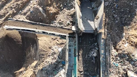 Drone view of a tire recycling facility with a large pile of old car tires Stock Footage 294722818