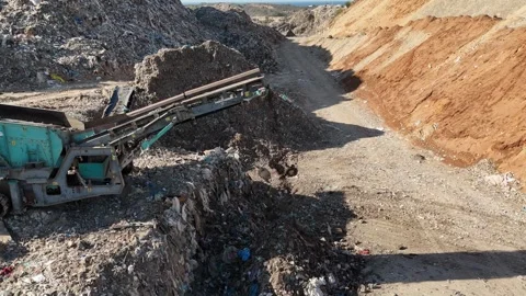 Drone view of a tire recycling facility with a large pile of old car tires Stock Footage 294722879