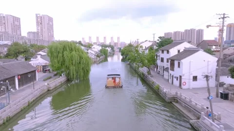 Drone view of tour boat and willow trees on Wuxi canal Stock Footage 345046337
