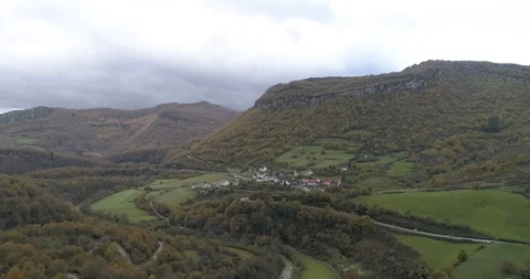 Drone view of a town surrounded by beautiful autumn foliage in Navarra, Spain Stock Footage 111836870
