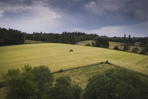 Drone view of a tractor on a field Stock Photos