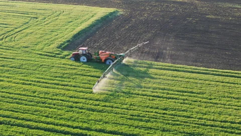 Drone View of Tractor Spraying Crops. Modern Farming at Work Stock Footage 310163749