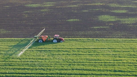 Drone View of Tractor Spraying Crops. Modern Farming at Work Stock Footage 310439074