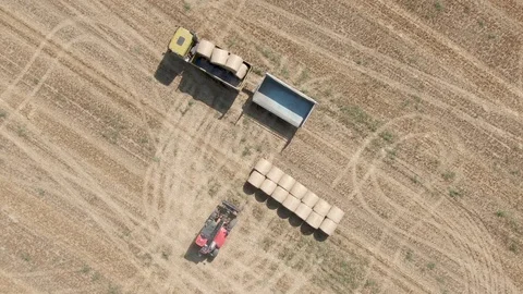 Drone view of tractor uploads bales to truck Stock Footage 127105807