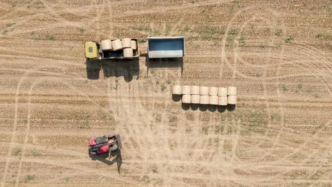 Drone view of tractor uploads bales to truck Stock Footage 127105862