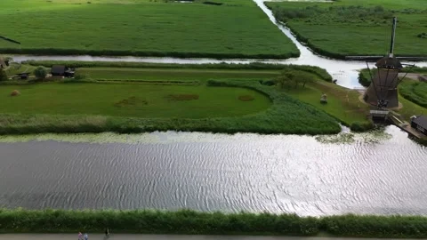 Drone view of a traditional Dutch windmill at Kinderdijk, surrounded Stock-Footage 313824673