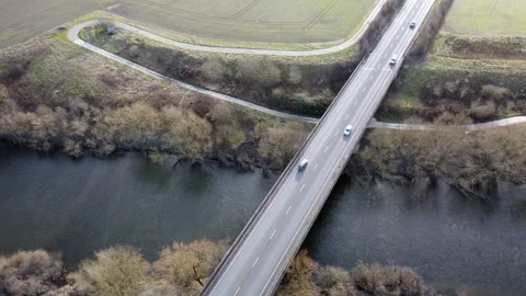 Drone view of traffic on a road bridge over a river, 4K Video stock 234794970