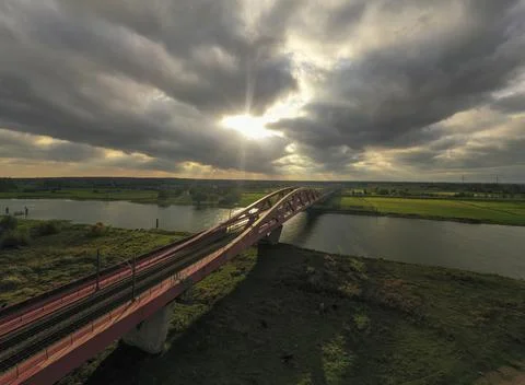 Drone view train bridge at sunset with big clouds Fotos de archivo