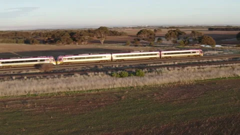 Drone view of Train passing by on Countryside Sunset beautiful view of Victoria Stock Footage 201699876