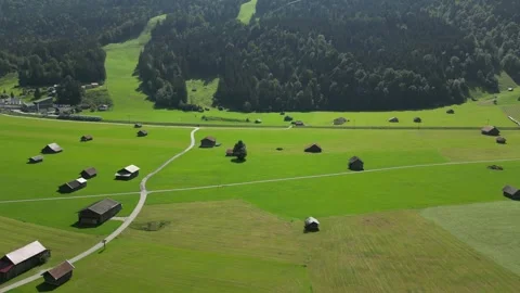 Drone View of Train Traveling Through Green Bavarian Fields Near Zugspitze Stock Footage 296923873