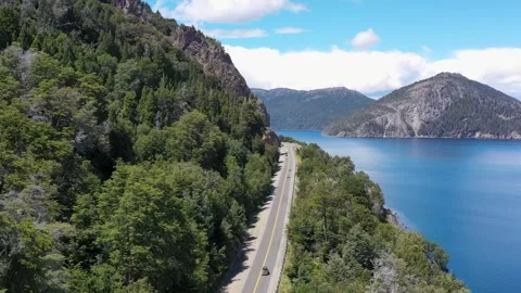 Drone view of travellers driving through the Ruta de los Siete Lagos Stock Footage 264095429