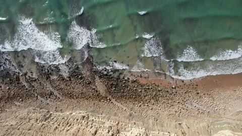 Drone view turquiose sea waves breaking on sandy coastline golden beach Stock Footage 165625357