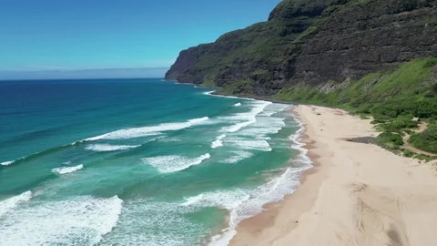 Drone view of turquoise waves rolling onto a golden beach in Hawaii Stock-Footage 347825950
