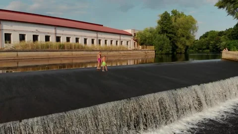 Drone view of two young guys walking along a dam in the Czech Republic Stock Footage 254918302