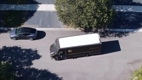 Drone view of UPS courier van delivering mail and parcels to their destination Stock Footage 321042705
