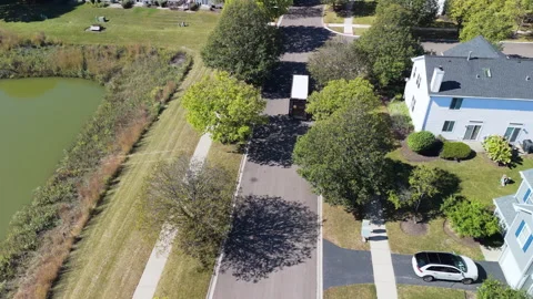 Drone view of UPS courier van delivering mail and parcels to their destination Stock Footage 321116579