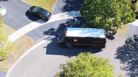 Drone view of UPS courier van delivering mail and parcels to their destination Stock Footage 321117041