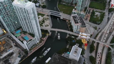 Drone view of various modern yachts and boats floating on Miami River with Draw Stock Footage 254438617