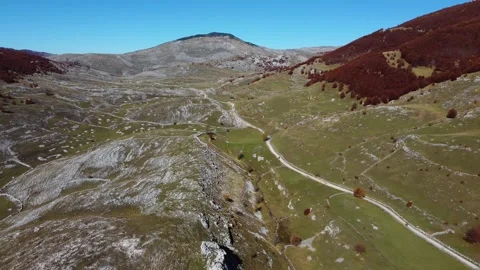 Drone view of vast fields in the mountains. Road village. Rural area. Stock Footage 182326488